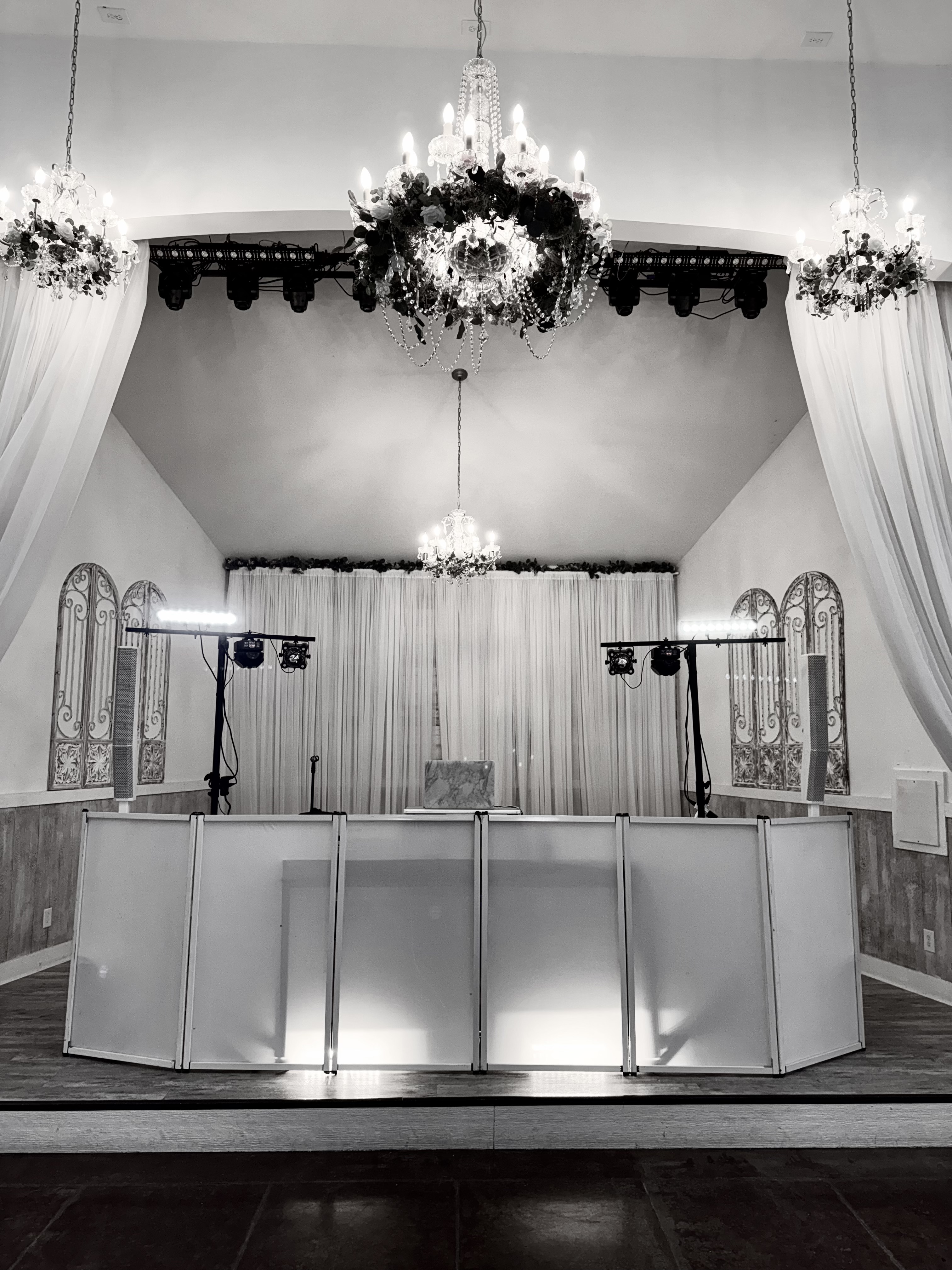 Elegant chandelier venue with DJ Ballallday booth on stage